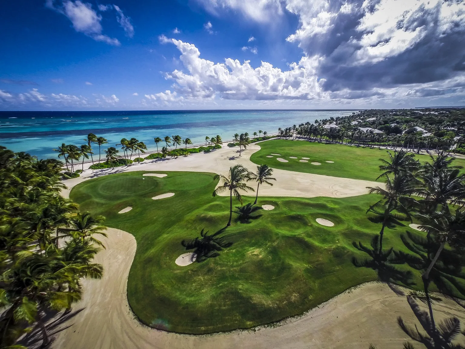 Aerial view of La Cana Golf Course fairways beside the Caribbean