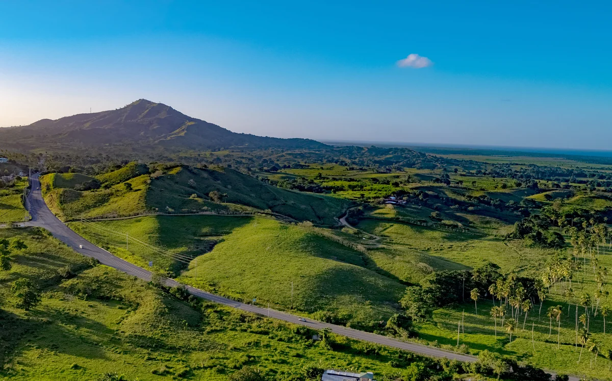 Punta Cana–Miches road winding through green hills toward the Atlantic coast