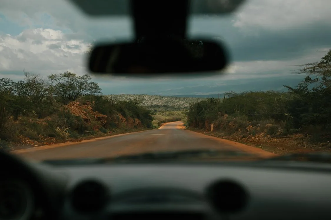 View through a car windshield along a green Dominican Republic road