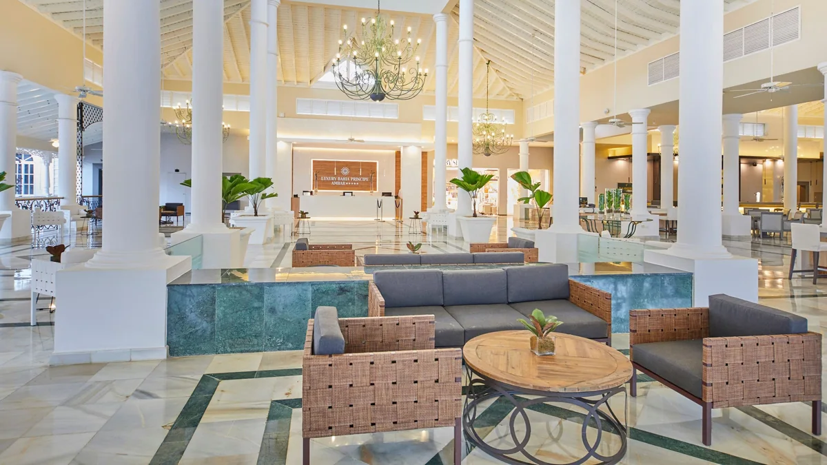 Ambar lobby with white columns, lounge seating and reception