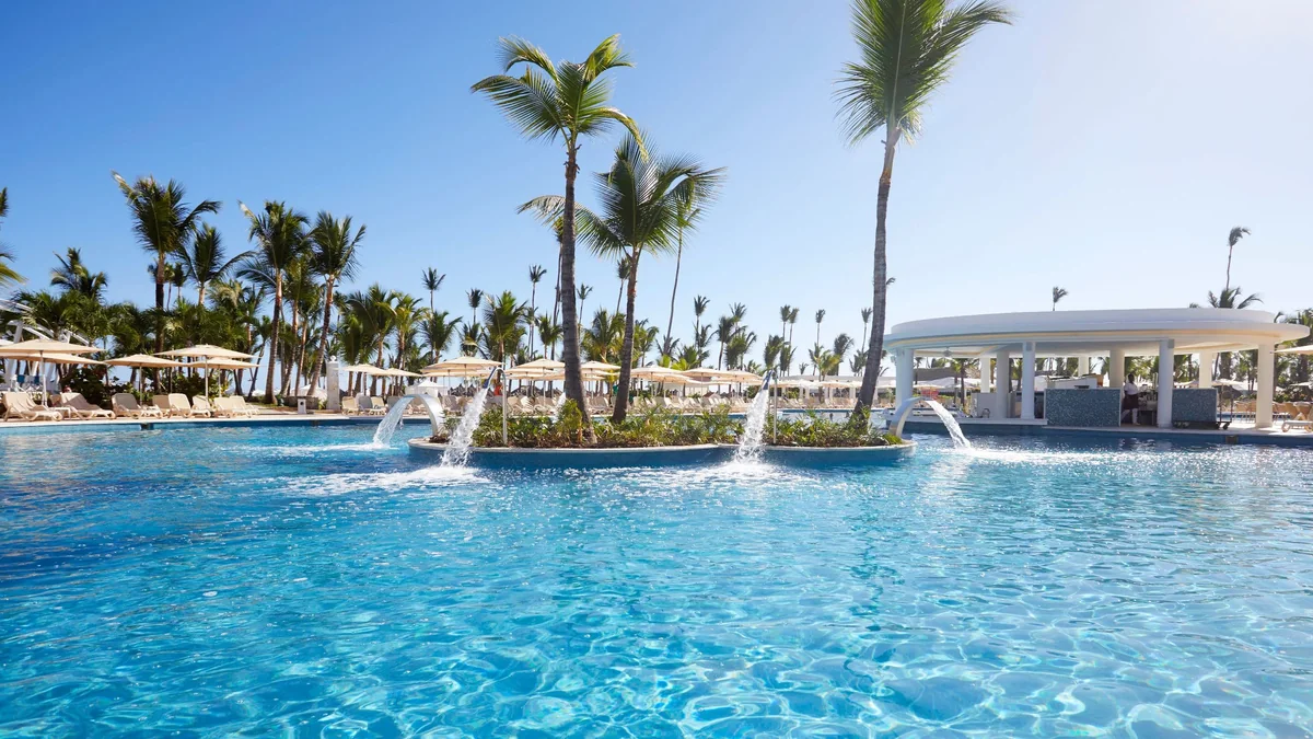 Main pool at Bahia Principe Escape Ambar with palms and fountains