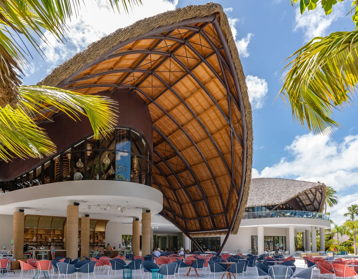 Curved thatched roofs and resort buildings at Club Med Michès Playa Esmeralda