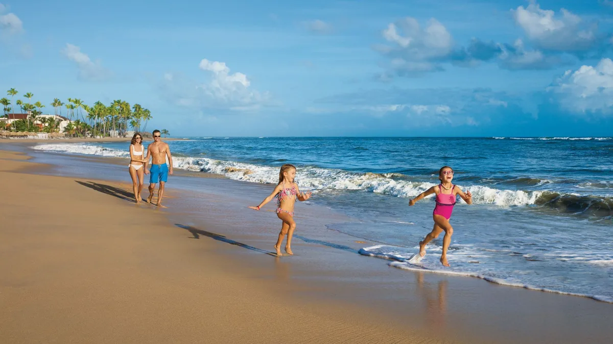 Family on the beach beside Dreams Onyx Resort & Spa in Uvero Alto