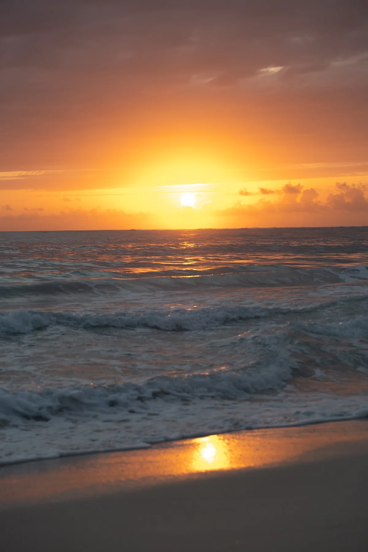 Sunset over waves at Punta Cana beach