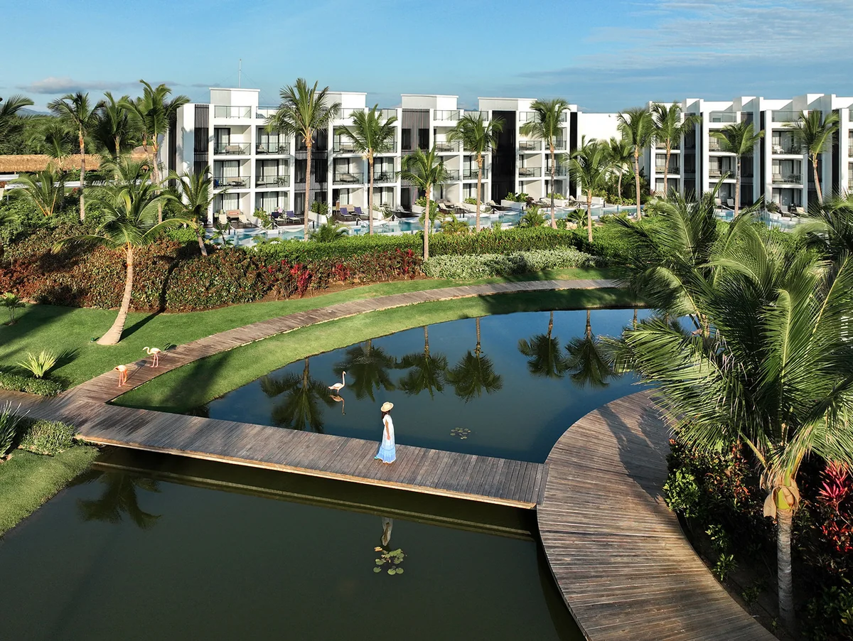 Garden lake, palm trees and suites at Finest Punta Cana
