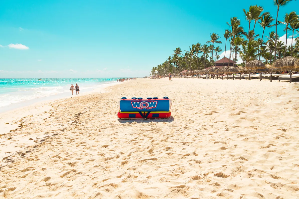 Inflatable water-activity equipment on a broad palm-lined Punta Cana beach