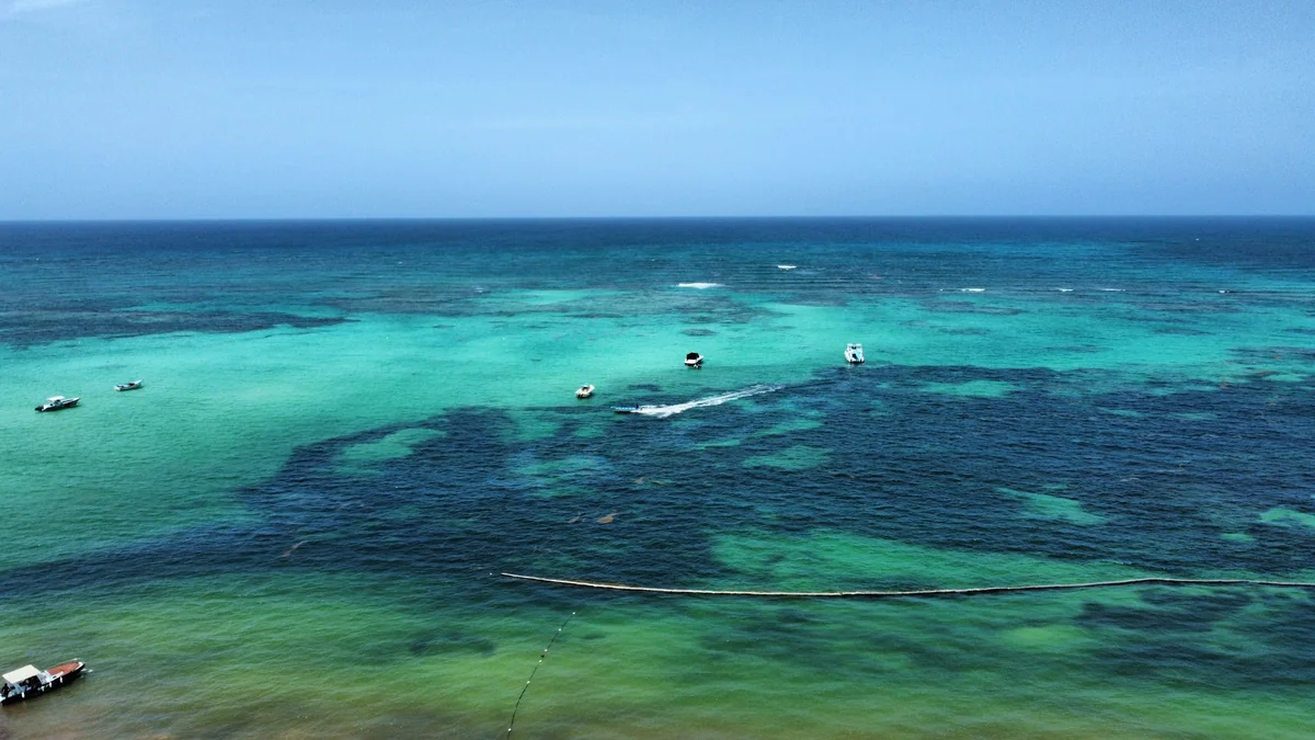 Aerial view of turquoise water and boats in Punta Cana
