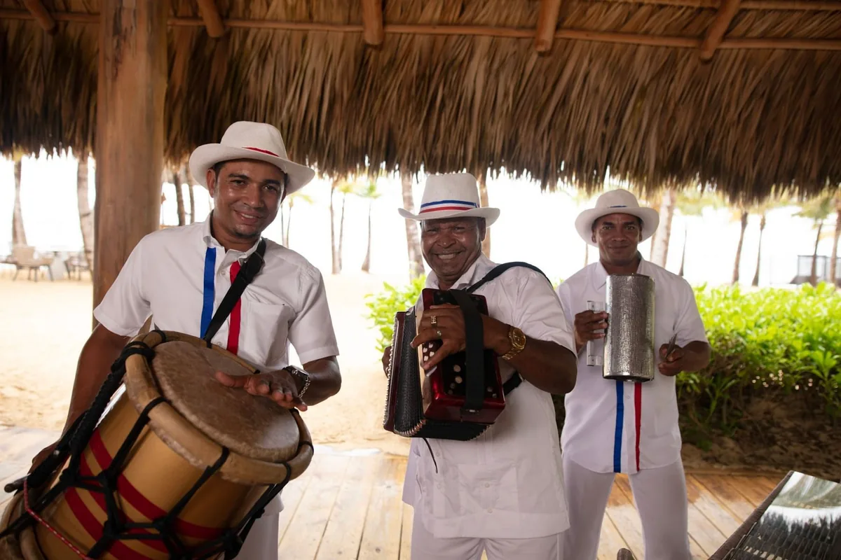 Musicians performing beneath a thatched roof at Live Aqua Punta Cana