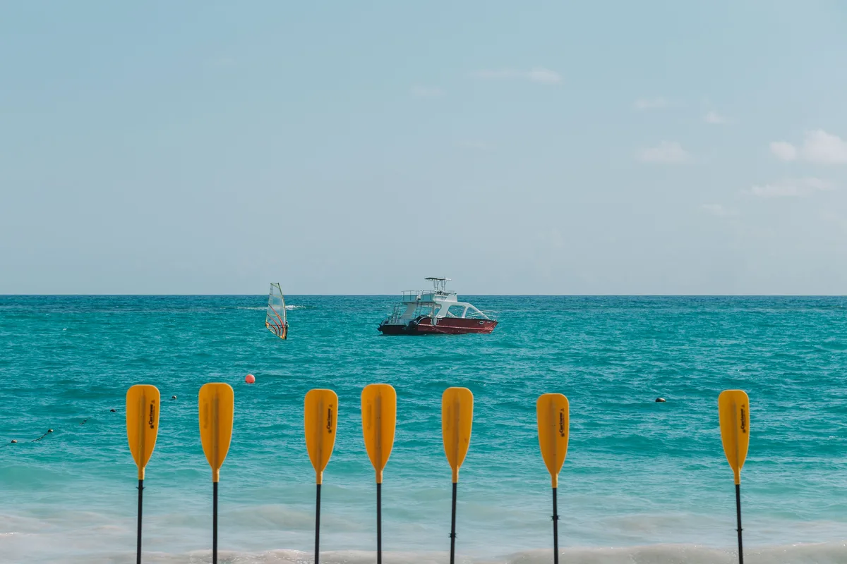 Paddles and boats on a Punta Cana beach for itinerary-planning context