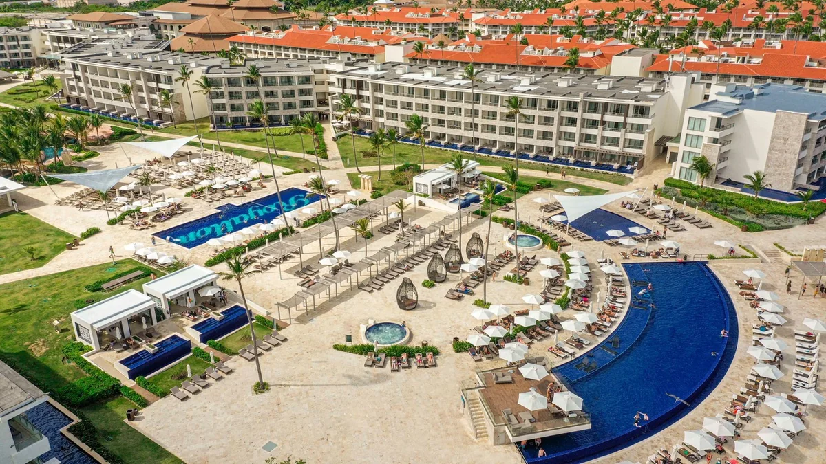 Curved blue swimming pools and guest buildings at Royalton Bavaro