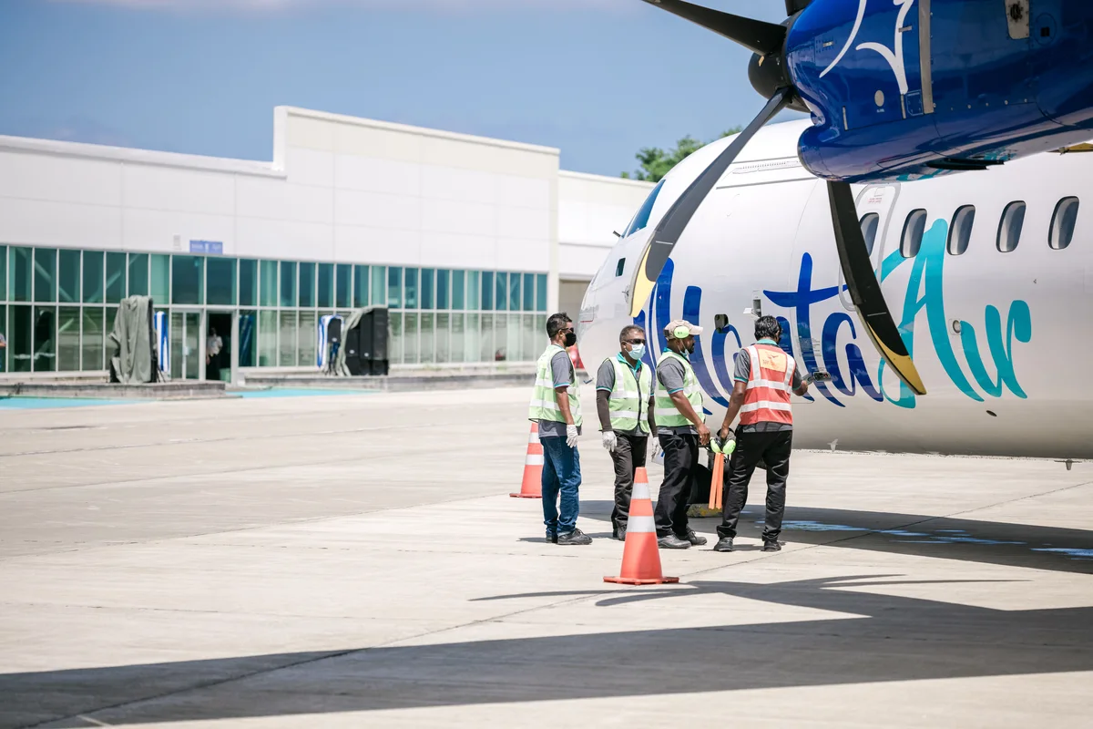 Airport workers beside an airplane in the Dominican Republic