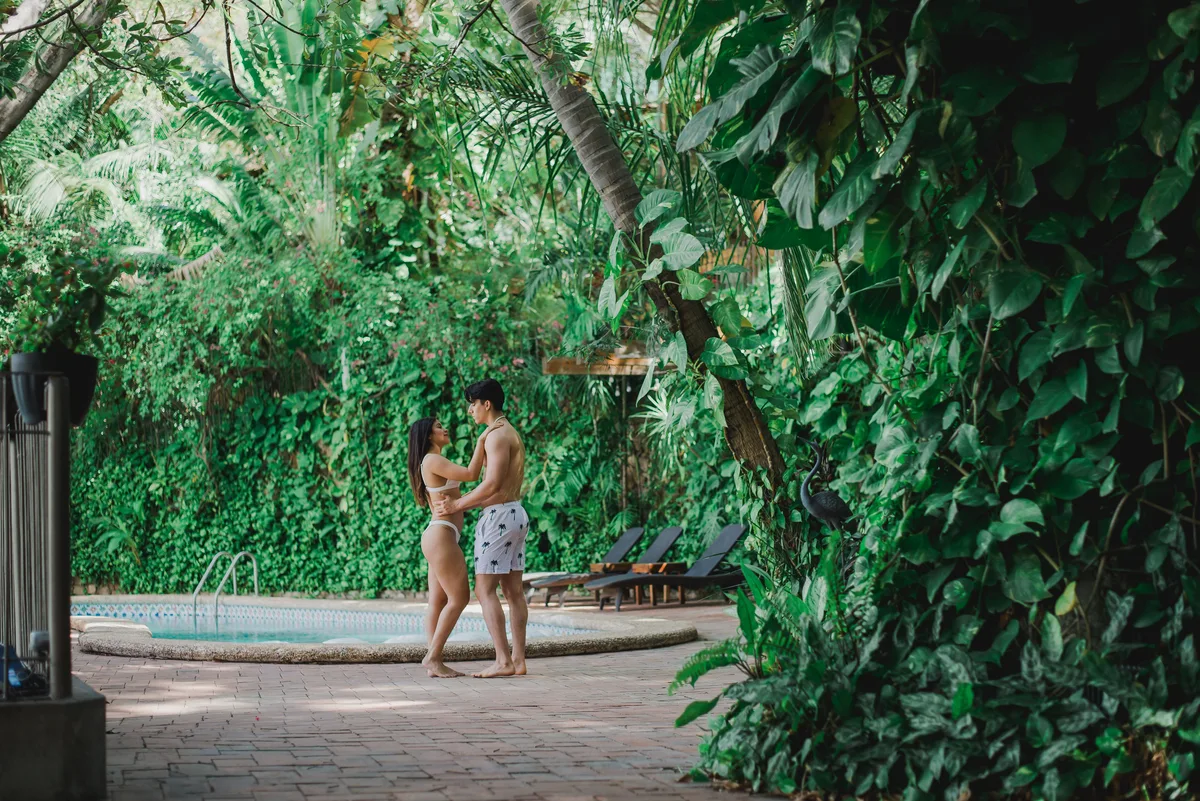Couple beside a generic tropical resort pool for adult-trip planning context
