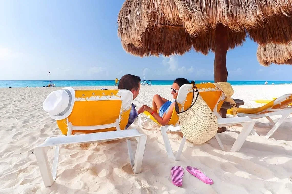 Beach loungers and shoreline at Serenade Punta Cana Beach & Spa Resort