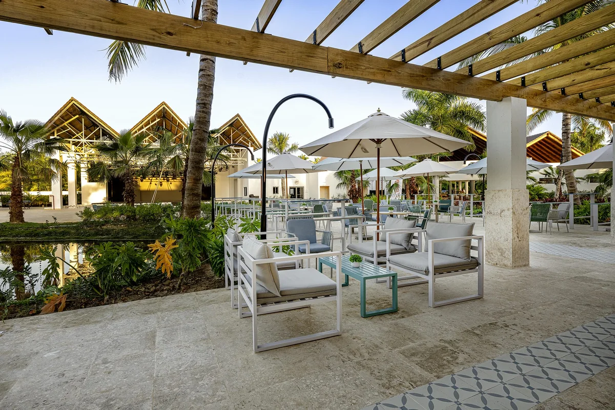 Shaded terrace beside a water garden at Viva Miches