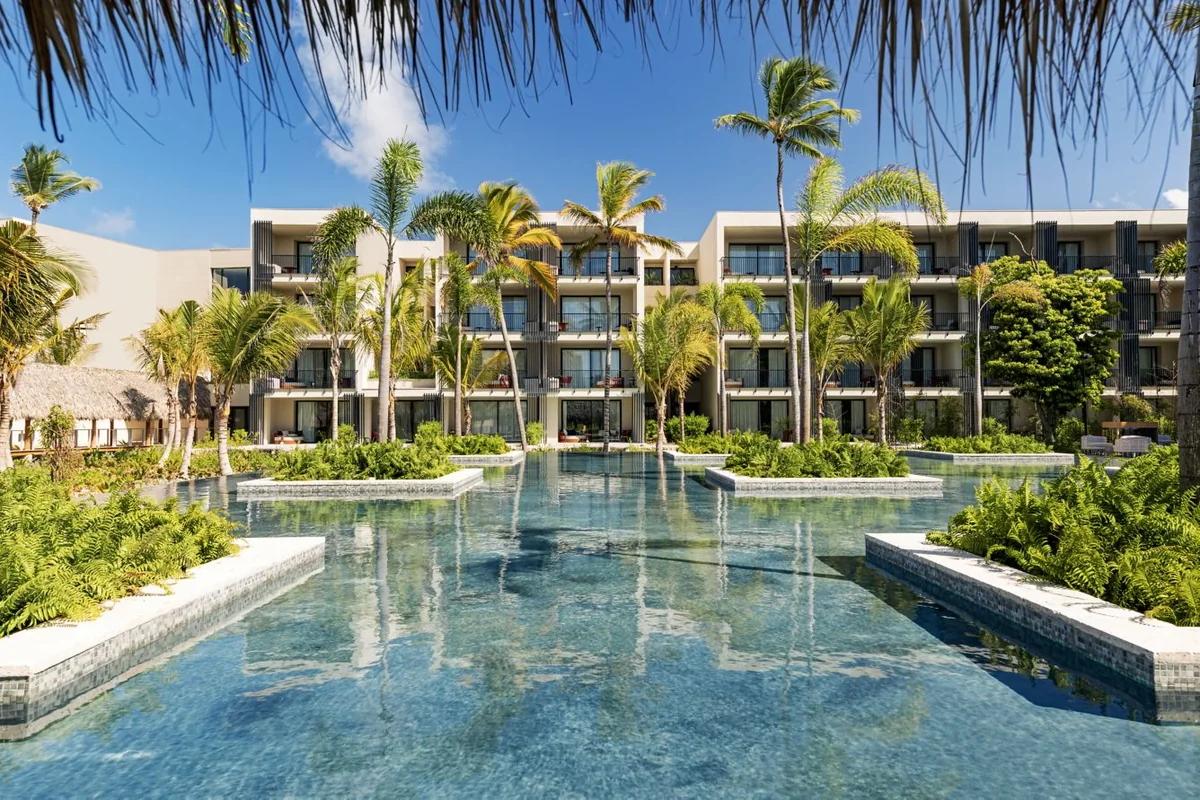 Pool, tropical gardens and hotel buildings at W Punta Cana