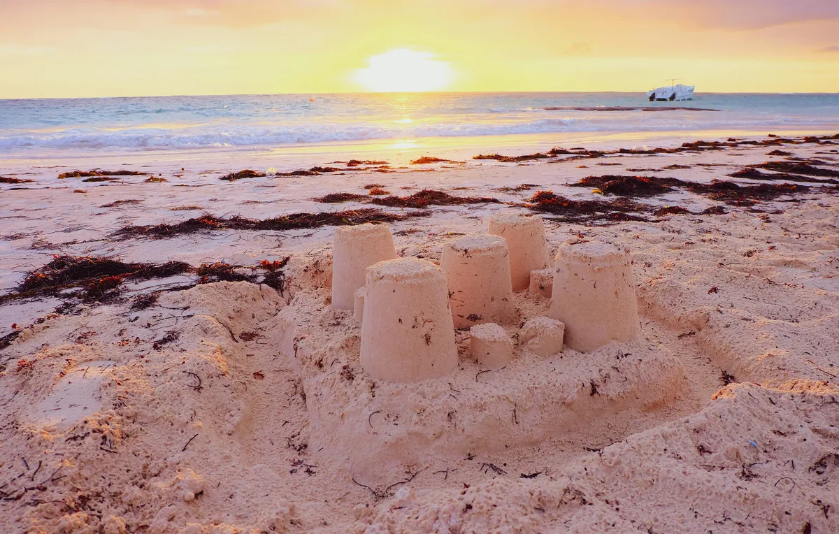 Sandcastle on a Punta Cana beach at sunset