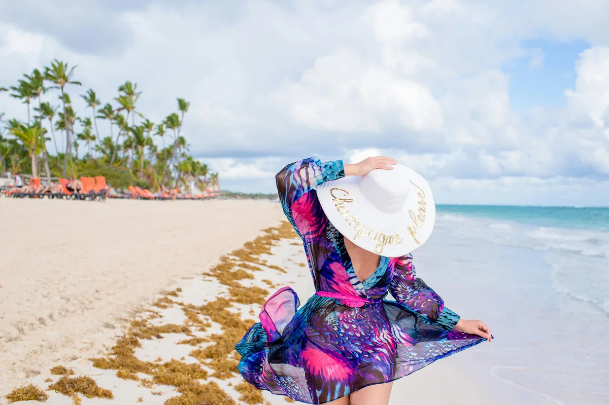 Traveller in a colourful cover-up beside the sea in Punta Cana