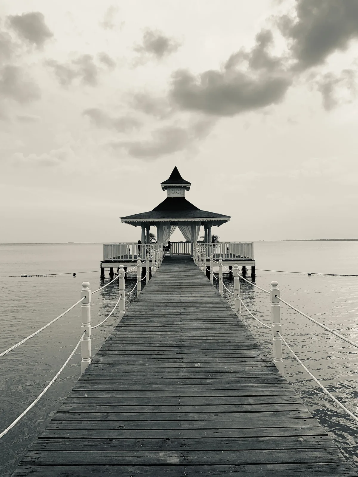 Wooden pier leading to a covered gazebo in Punta Cana
