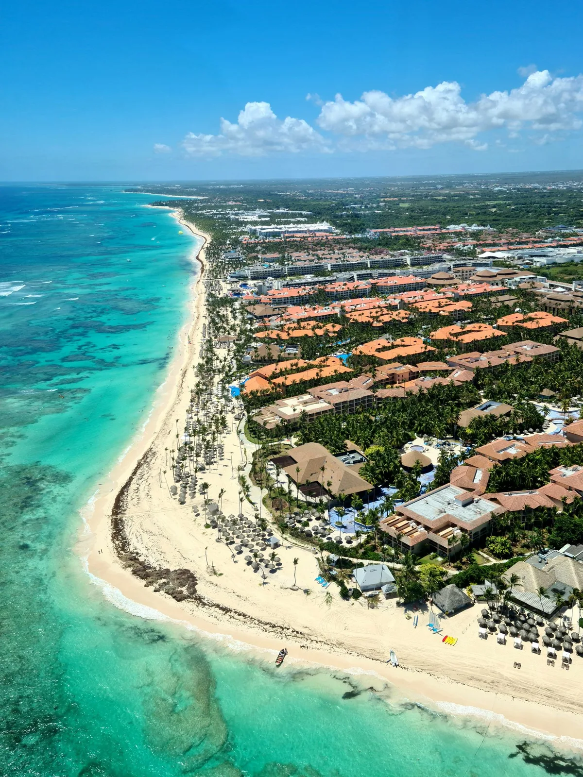 Aerial Punta Cana coastline with turquoise water and resort-lined shore